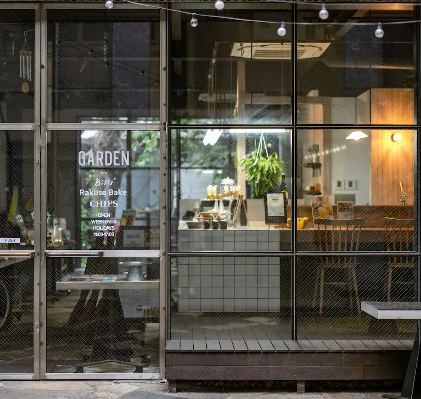 Welcoming café interior visible through a wall of glass windows